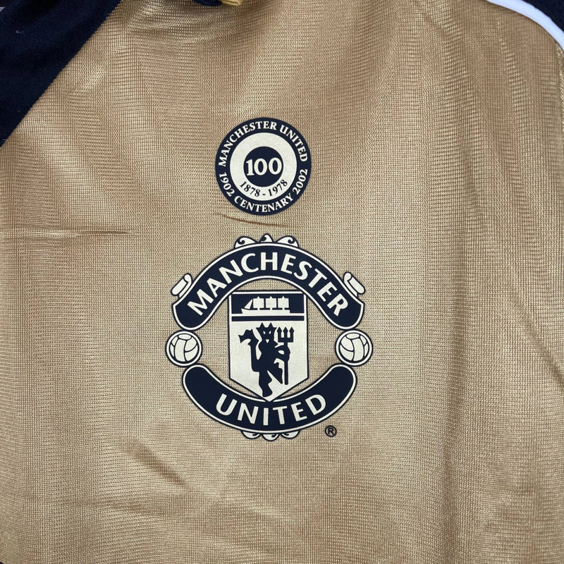 Camisa Dupla Face Retrô Manchester United Umbro 2001/02 100 Anos Masculina Branca e Preta ou Dourada